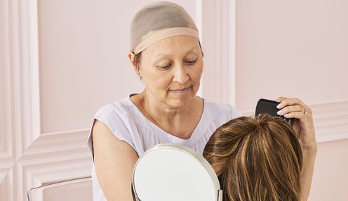 Shot28_Participant looking in mirror adjusting wig_0121.jpg